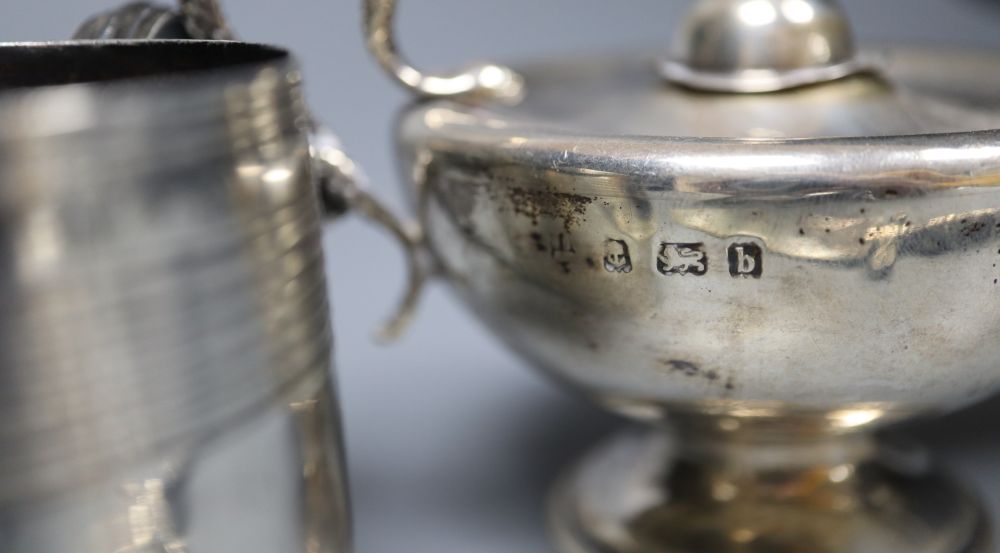 A George III reeded silver small mug, London, 1807, 6.3cm, an Edwardian Aladdins lamp perpetual lighter and a paper knife.